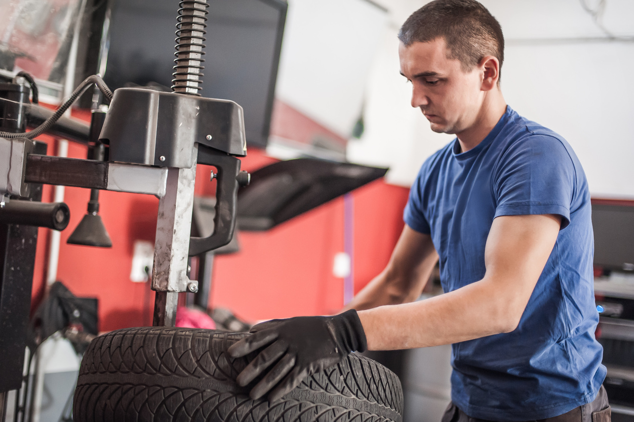 Car master mechanic vulcanizer repairing tire on auto vulcanizing machine